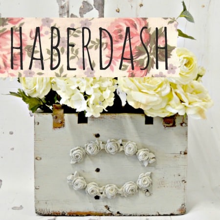 White wooden box with flowers, painted in Sweet Pickins Milk Paint by Old Fashioned Milk Paint, HABERDASH sign above.