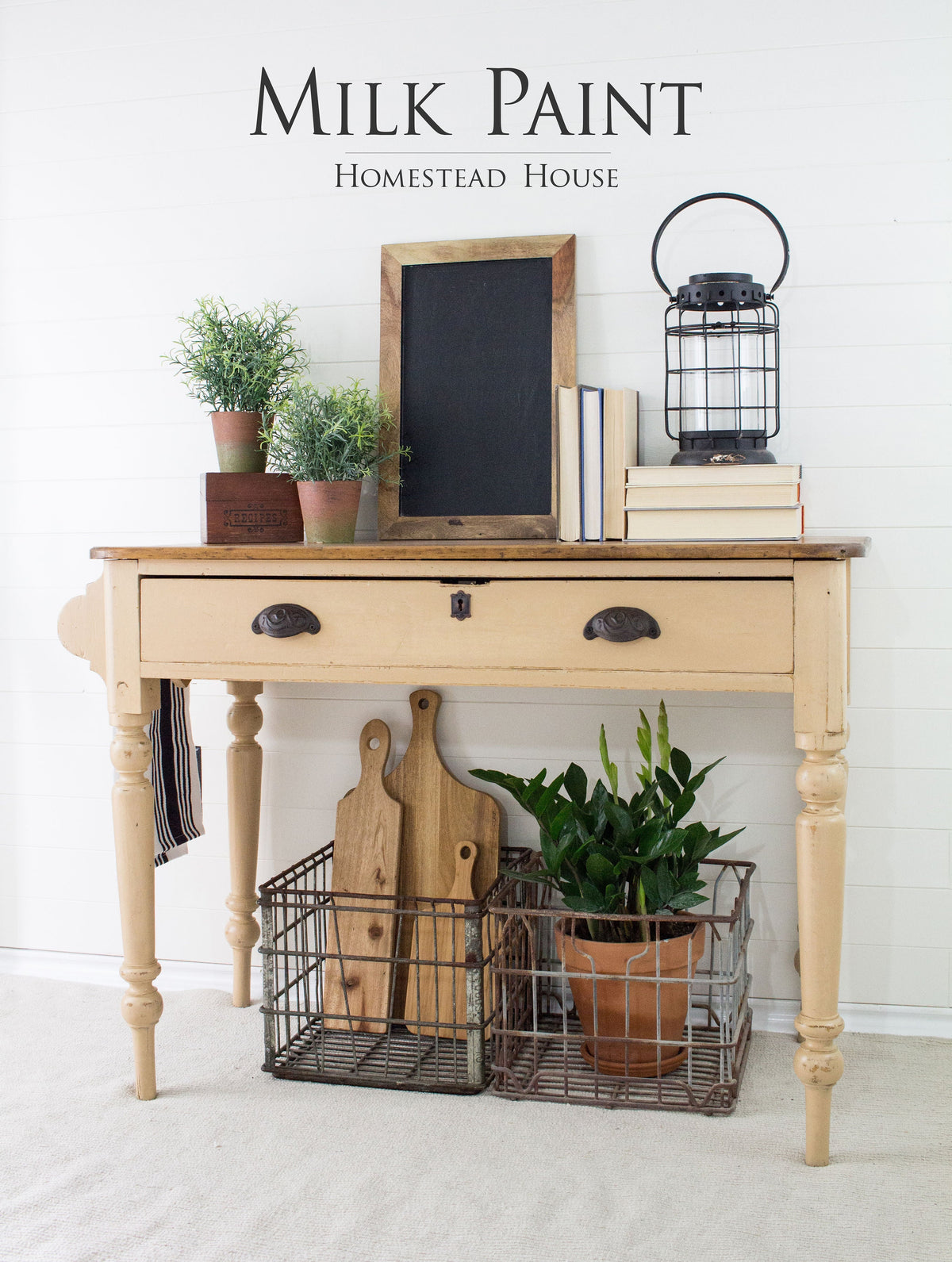 Beige wooden table with decor accents, finished with Homestead House Hampton Milk Paint.