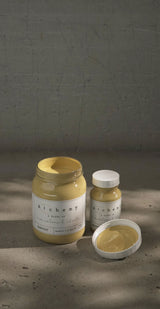 Three jars of Fusion Mineral Paint Harvest Alchemy; one jar is open showing yellow chalk paint.