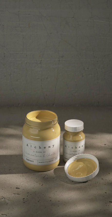 Three jars of Fusion Mineral Paint Harvest Alchemy; one jar is open showing yellow chalk paint.