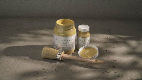 Two jars of Fusion Mineral Paint in Harvest Alchemy, one open with a brush.