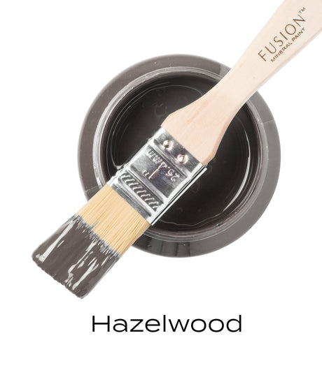 Brush with gray paint resting on open jar of Fusion Mineral Paint in Hazelwood.