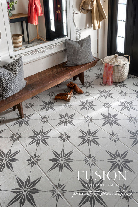 Long wooden bench with pillows on patterned tile, set against Hazelwood Fusion Mineral Paint near boots and mirror.