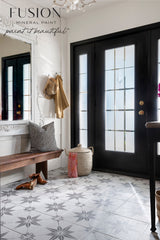 Patterned tile floor, wood bench, and black double doors painted in Hazelwood Fusion Mineral Paint.