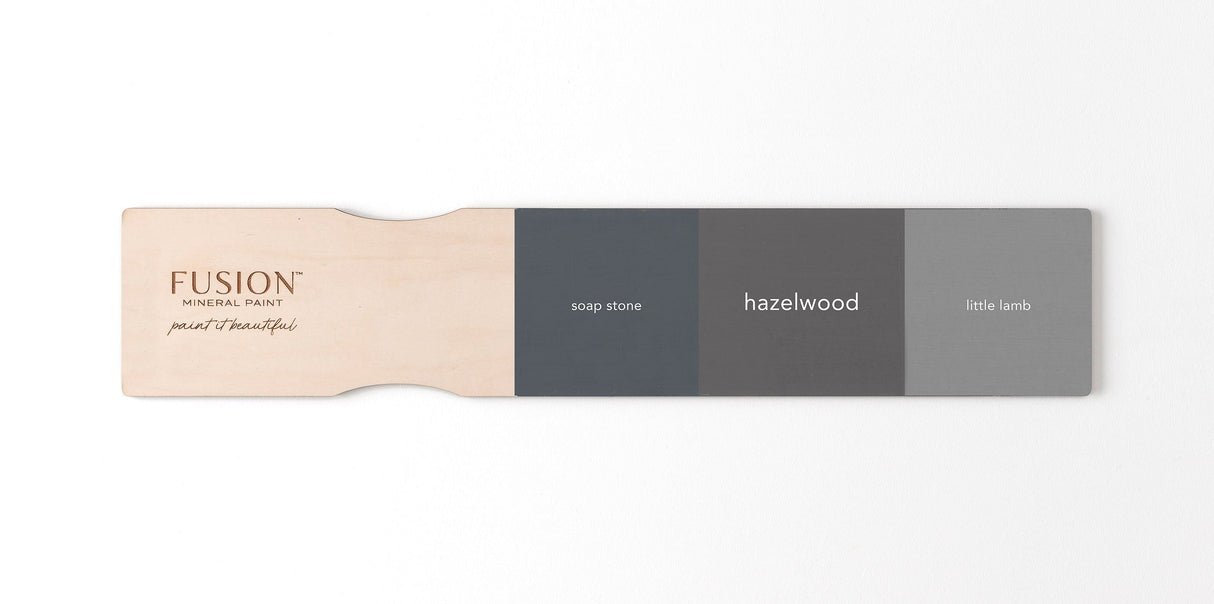Soap Stone, Fusion Mineral Paint’s Hazelwood, and Little Lamb shades displayed on a wooden paint paddle.