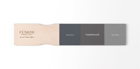 Soap Stone, Fusion Mineral Paint’s Hazelwood, and Little Lamb shades displayed on a wooden paint paddle.