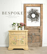 Yellow Hollandaise-painted cabinet by Old Fashioned Milk Paint, floral top, twig wreath, BESPOKE collection.