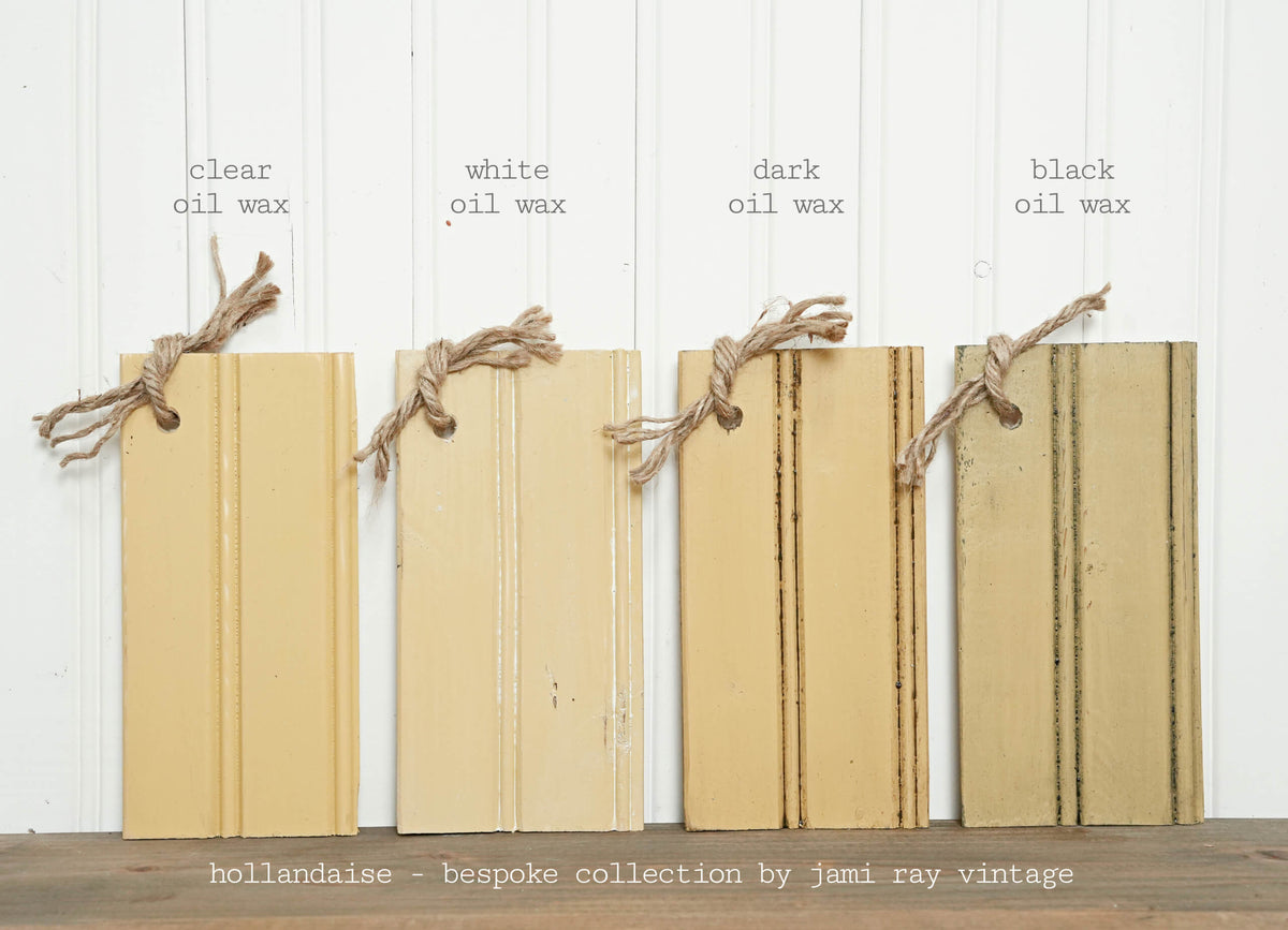 Four wood samples with clear, white, dark, and black finish in Hollandaise by Old Fashioned Milk Paint, each tied with twine.