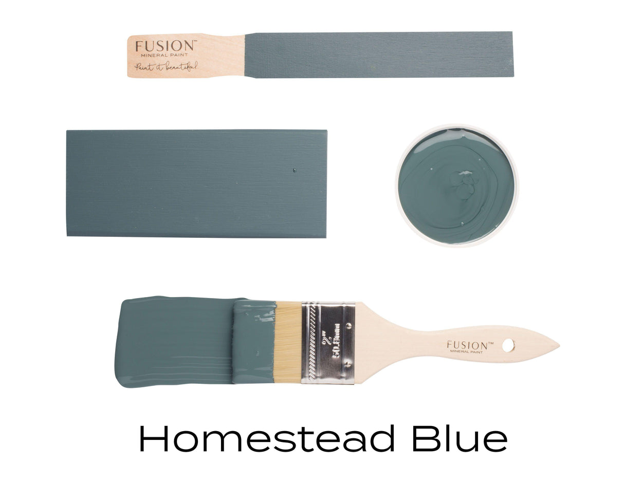 Four Homestead Blue Fusion Mineral Paint samples, two brushes, swatch, and small paint bowl arranged together.