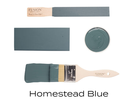 Four Homestead Blue Fusion Mineral Paint samples, two brushes, swatch, and small paint bowl arranged together.