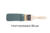 Paintbrush with Homestead Blue Fusion Mineral Paint by Fusion Mineral Paint on a white background.
