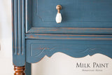 Blue wood cabinet in Homestead Blue Milk Paint by Homestead House with a white knob and visible brand text.
