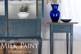 Blue side table, cabinet, vase, and bowl with “Homestead Blue Milk Paint by Homestead House” text.