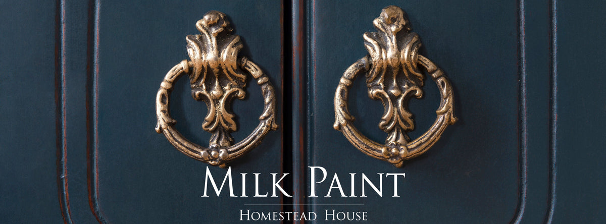 Two gold door knockers on a dark blue door finished in Homestead Blue Milk Paint by Homestead House.