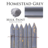 Homestead House Homestead Grey Milk Paint grey powder with painted molding and distressed picket fence samples shown.
