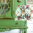 Green vintage cabinet painted in In A Pickle by Old Fashioned Milk Paint beside a floral “in a pickle” sign.