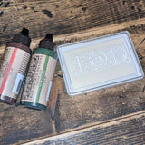 IOD Two Bottles of Ink and Uninked White Ink Pad set for use with IOD stamps.