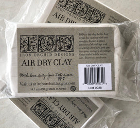 IOD Air Dry Clay by Iron Orchid Designs, includes artist-grade clay for IOD Moulds, note, and barcode visible.