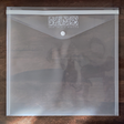 I.O.D. IOD Stamp Storage Envelope, clear plastic with button closure, for storing stamps.
