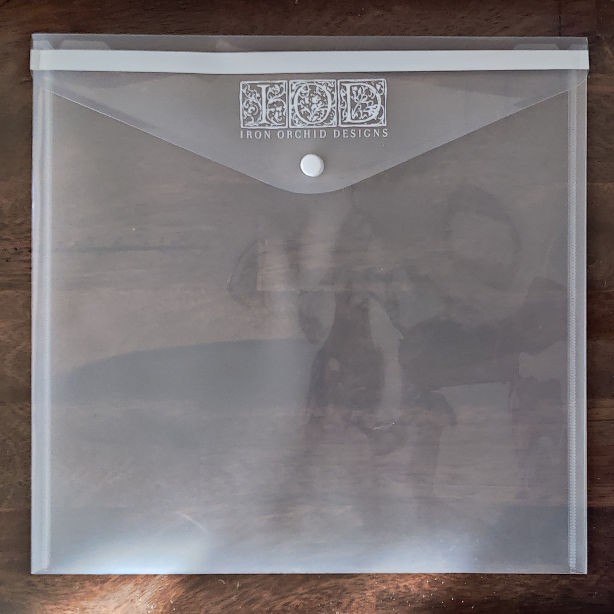 I.O.D. IOD Stamp Storage Envelope, clear plastic with button closure, for storing stamps.