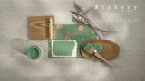 Alchemy by Fusion Digital Downloads with dried plants, paintbrush, and board arranged on a textured surface.