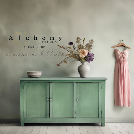 Green cabinet in Juniper Alchemy by Fusion Mineral Paint, with bowls, pink dress, and wall text in the background.