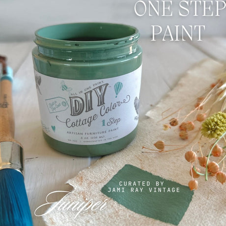 Juniper DIY Cottage Color by DIY Paint Co., open with brush, swatch, and dried flowers on light background.
