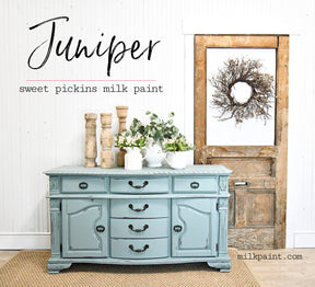 Sideboard painted in Juniper by Old Fashioned Milk Paint with vases and greenery displayed on top.