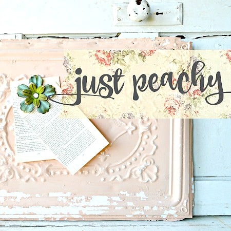 Just Peachy“ sign with floral accents, painted in Old Fashioned Milk Paint, plus paper flower and book.