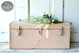 Trunk painted Just Peachy by Old Fashioned Milk Paint, with flowers arranged on top.