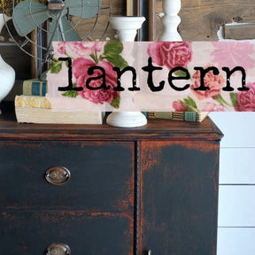 Floral fabric over dresser painted in Old Fashioned Milk Paint Lantern – Sweet Pickins, with books on top.