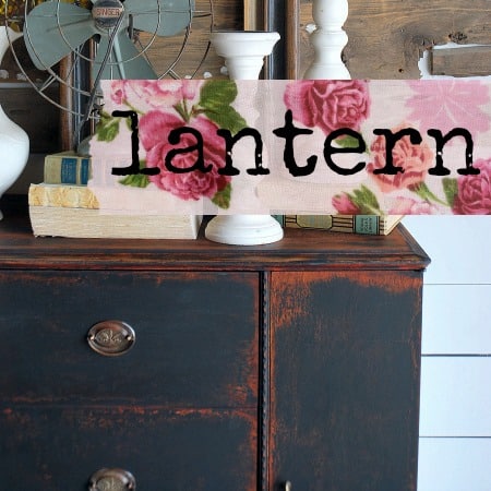 Floral fabric over dresser painted in Old Fashioned Milk Paint Lantern – Sweet Pickins, with books on top.