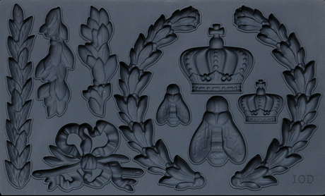 Laurel Mould by I.O.D. with crown, bee, ribbon, and laurel leaf motifs in a dark matte finish.
