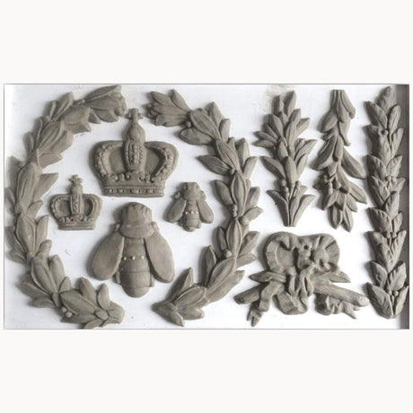 Gray clay shapes crafted with Laurel Mould by I.O.D., arranged on a white background.
