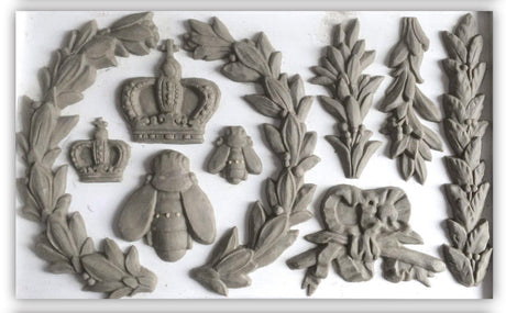 Clay shapes made with Laurel Mould by I.O.D. (Iron Orchid Designs) arranged on a white surface.