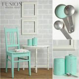 Chair and tins painted in Laurentien Fusion Mineral Paint by Fusion next to a white table.