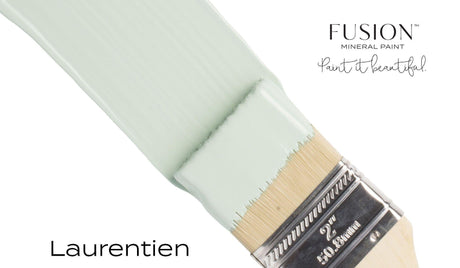 Paintbrush with Fusion Mineral Paint in Laurentien, a pale green seasonal color, from Fusion Mineral Paint.