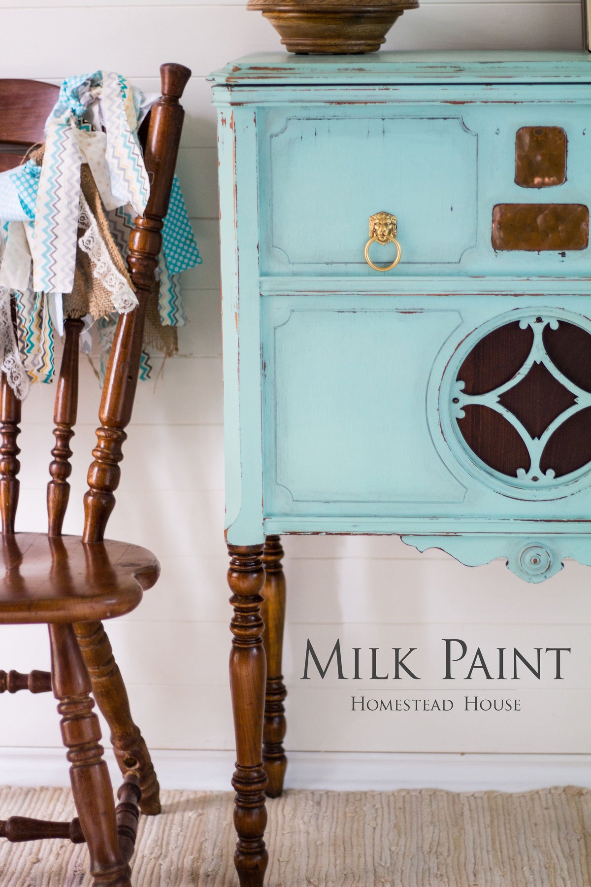 Antique wood chair beside blue Laurentien Milk Paint sideboard by Homestead House.