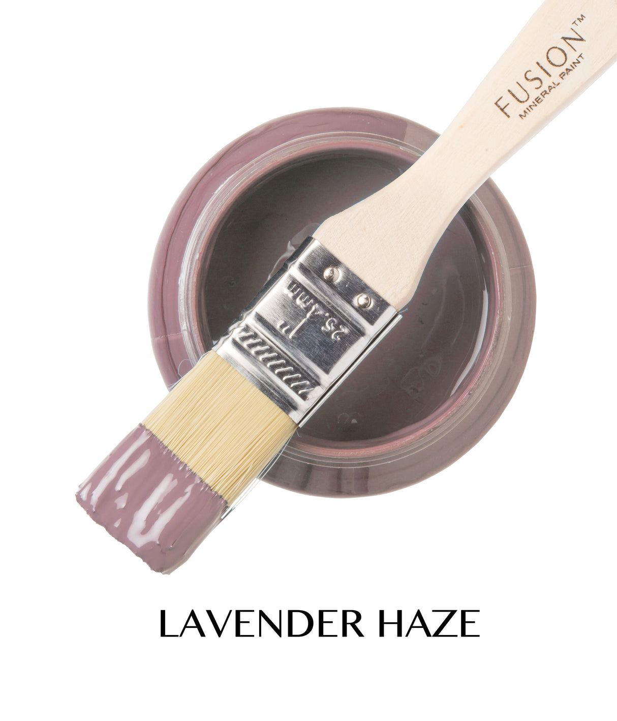 Brush dipped in Fusion Mineral Paint, color Lavender Haze, beside open jar labeled “LAVENDER HAZE.”.