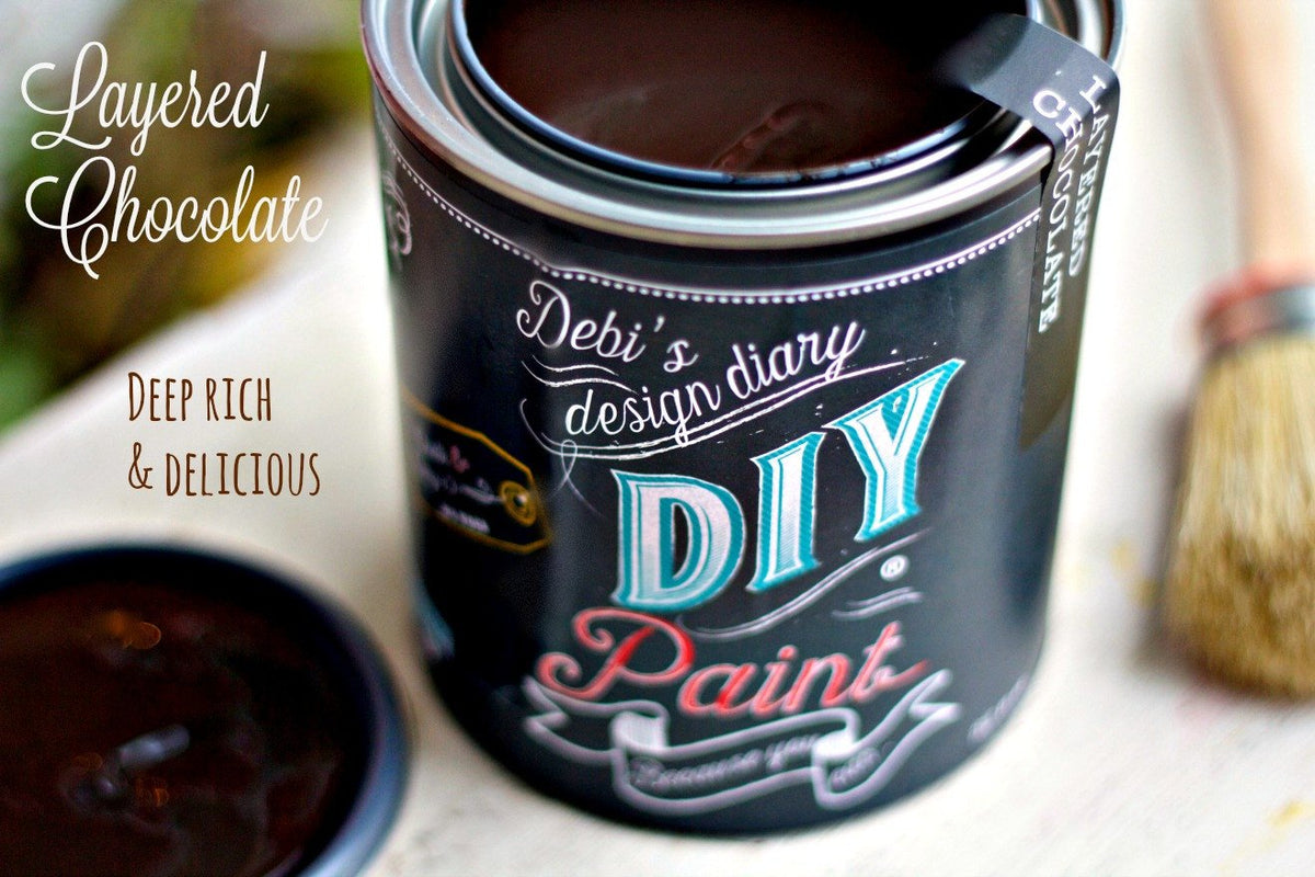 Open can of DIY Paint Co. Layered Chocolate clay and chalk-based paint with brush and lid nearby.
