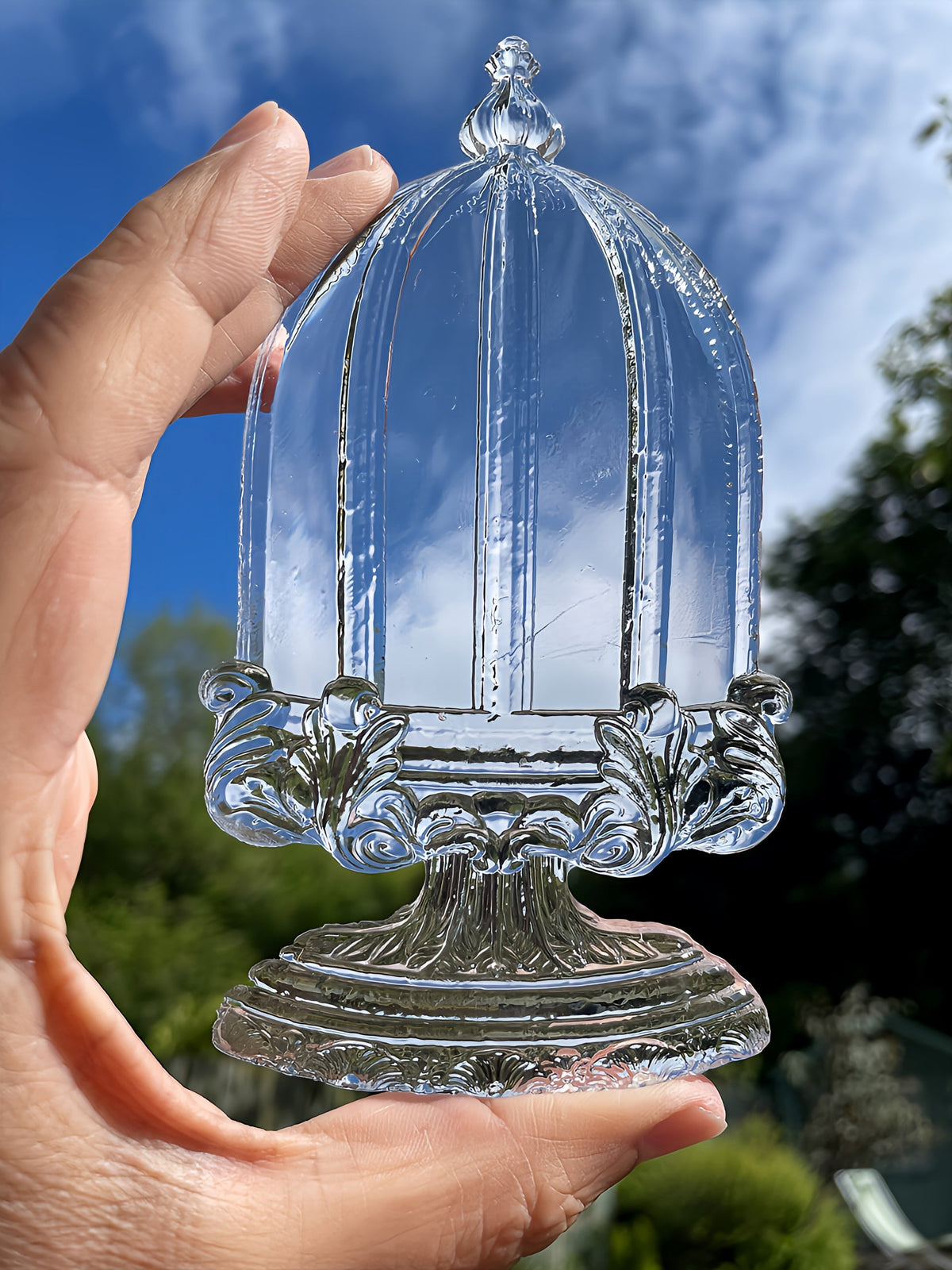 Hand holding Les Cloches Mould by I.O.D. from Iron Orchid Designs.