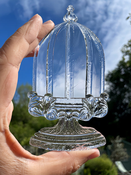 Hand holding Les Cloches Mould by I.O.D. from Iron Orchid Designs.