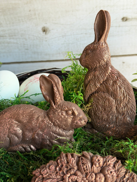 Two I.O.D. Les Lapins bunny shapes displayed on moss with white eggs.