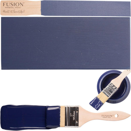 Paintbrush, blue swatch, and open jar of Liberty Blue Fusion Mineral Paint by Fusion Mineral Paint.