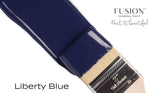 Brush with Fusion Mineral Paint, Liberty Blue shade, displayed on a plain white background.