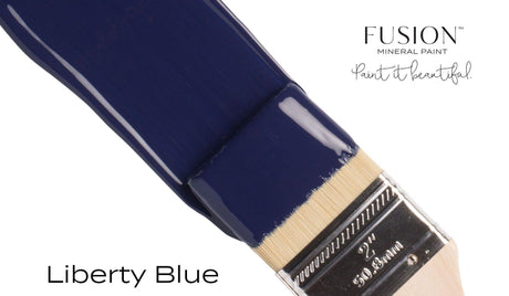 Brush with Fusion Mineral Paint, Liberty Blue shade, displayed on a plain white background.