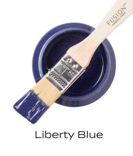 Open Fusion Mineral Paint jar in Liberty Blue with brush resting on top, “Liberty Blue” text below.