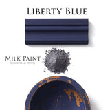 Navy wood trim in Homestead House Liberty Blue Milk Paint with gray powder and a chipped blue bowl on white background.