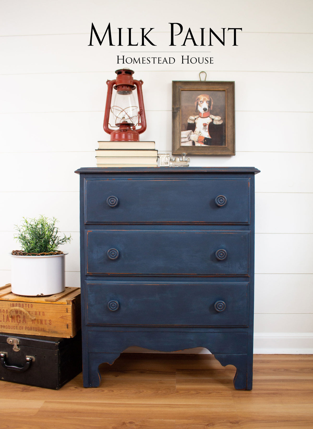 Liberty Blue Milk Paint three-drawer dresser by Homestead House, topped with books, a lantern, and a plant.
