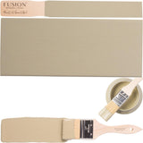 Paintbrush, wooden board, and can of Fusion Mineral Paint in Lichen color displayed side by side.